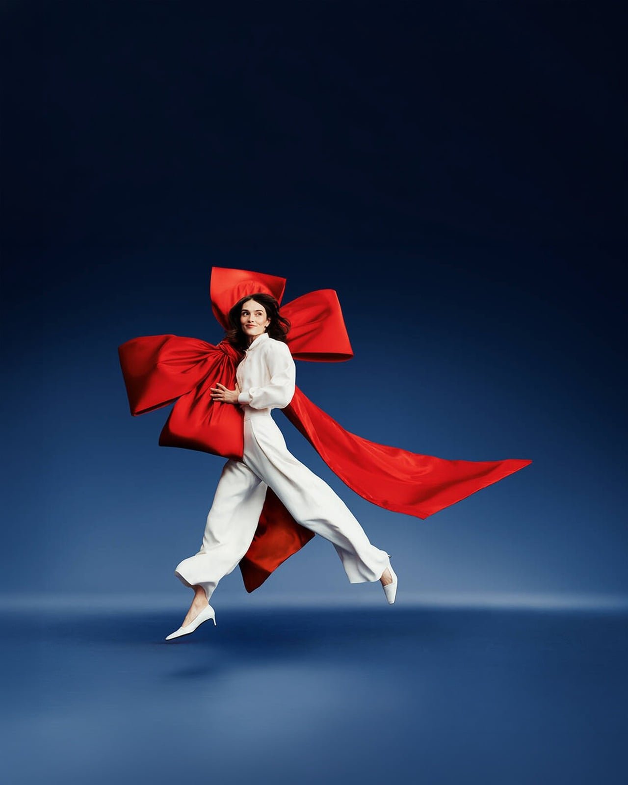 Model in white with a flowing red bow, from the Air France campaign
