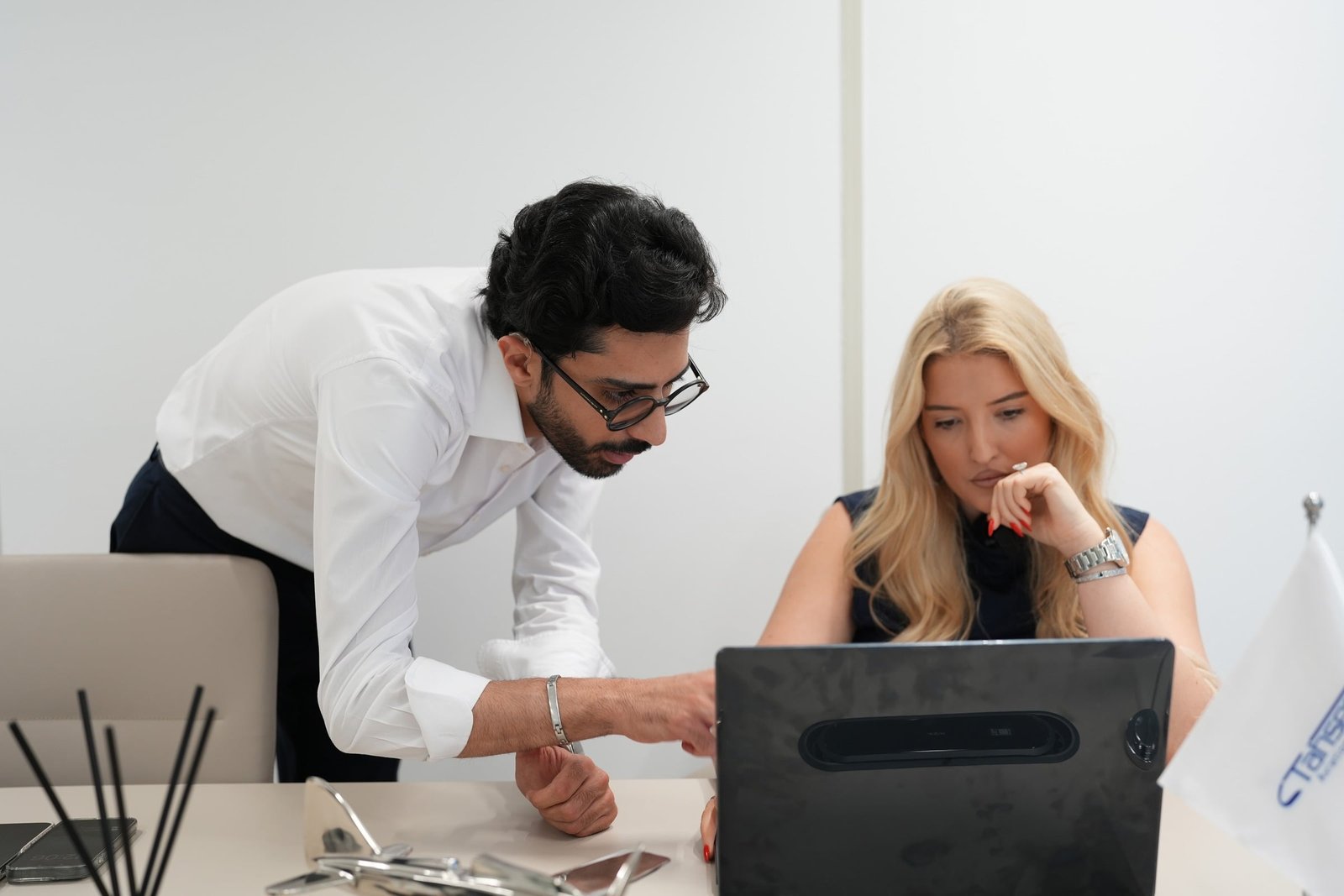 ONIX team reviewing work on a laptop